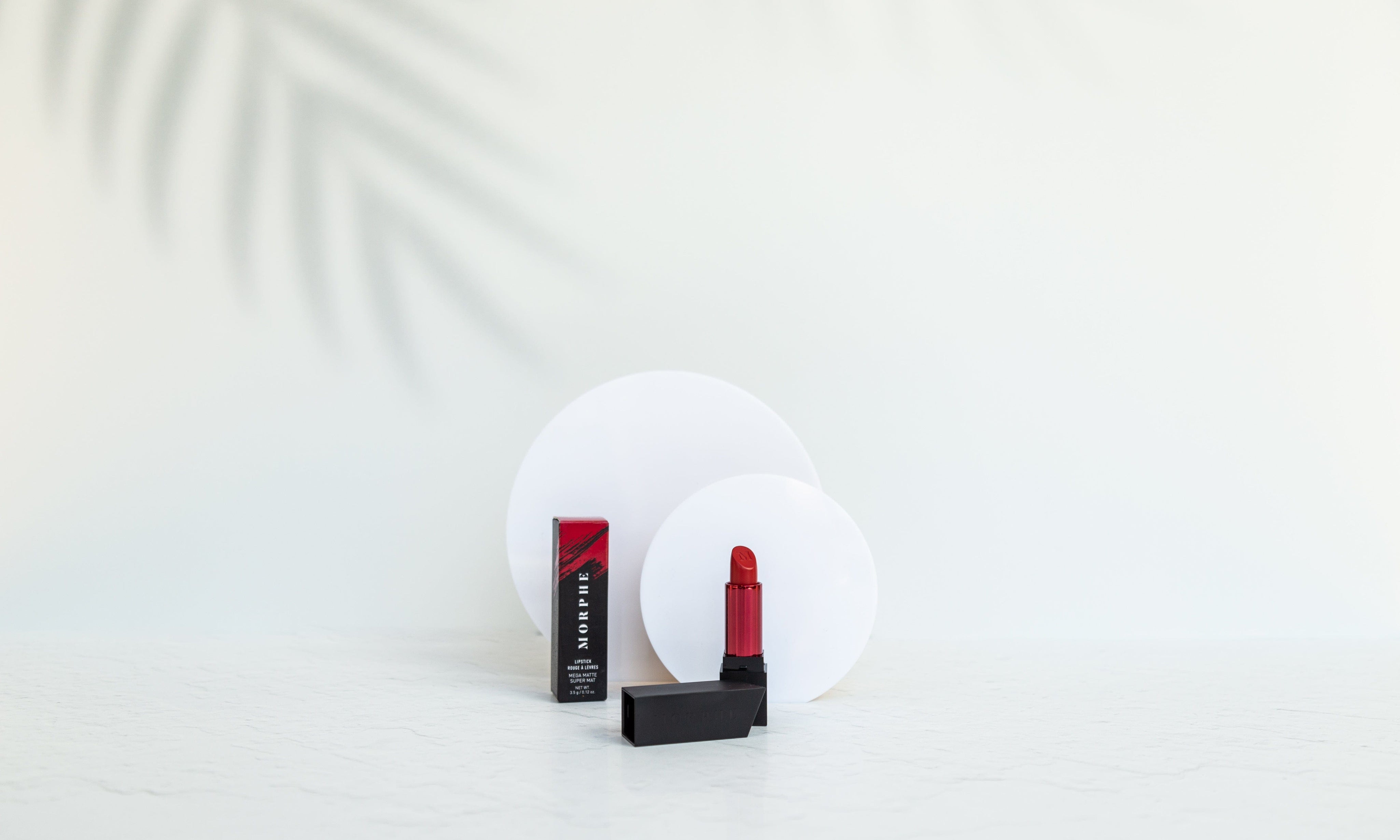 palm tree shadow white vinyl. backdrop photographed with circle acrylic props and red morphe lipstick product photography - backdrop collective australia