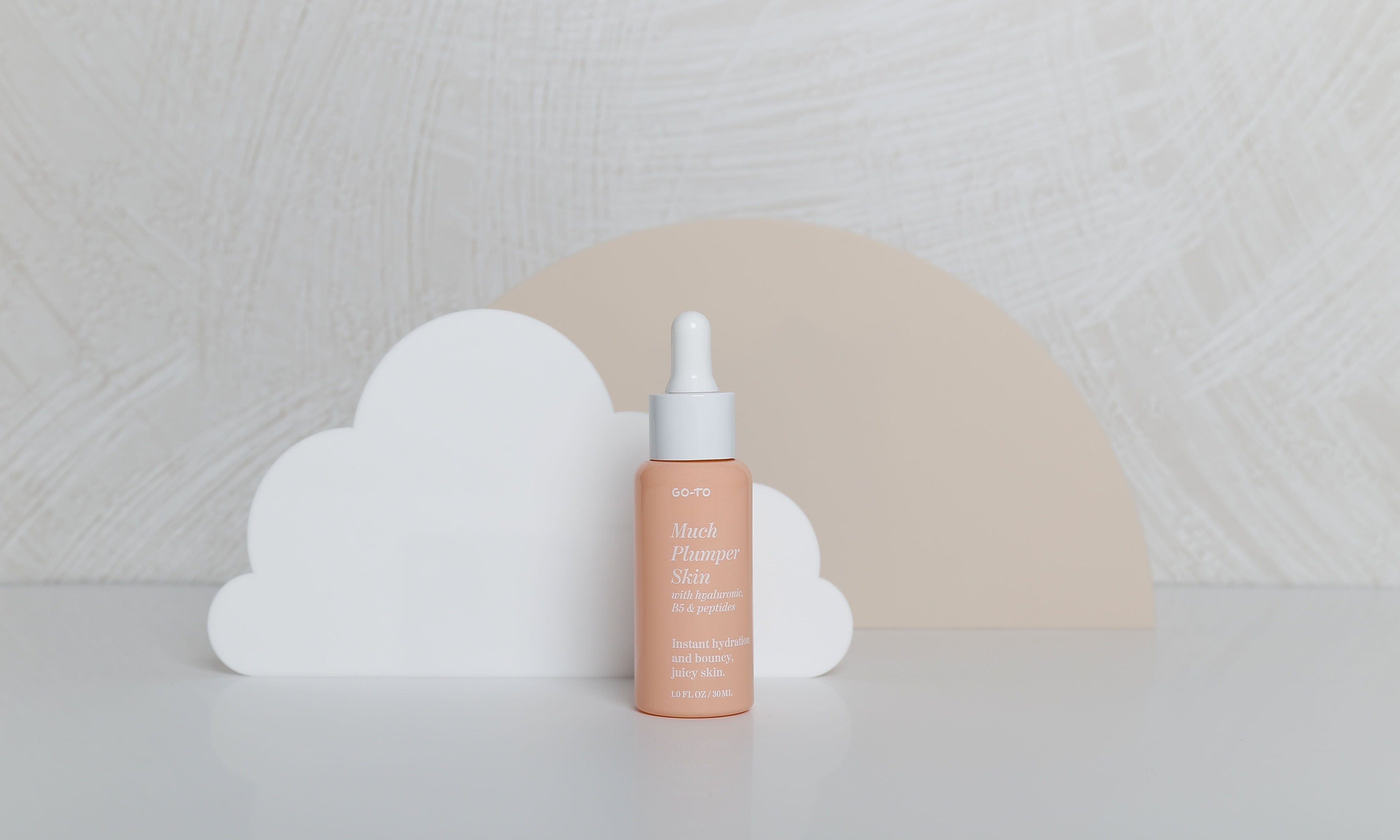brushed white concrete textured waterproof vinyl photography backdrops for product photography with acrylic cloud and beige circle props - backdrop collective