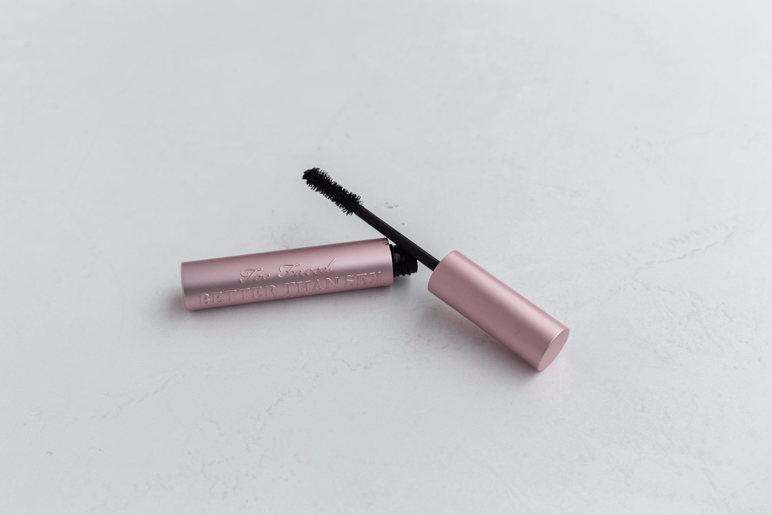 Too Faced better than sex mascara on white concrete double-sided vinyl photography backdrop - backdrop collective australia 