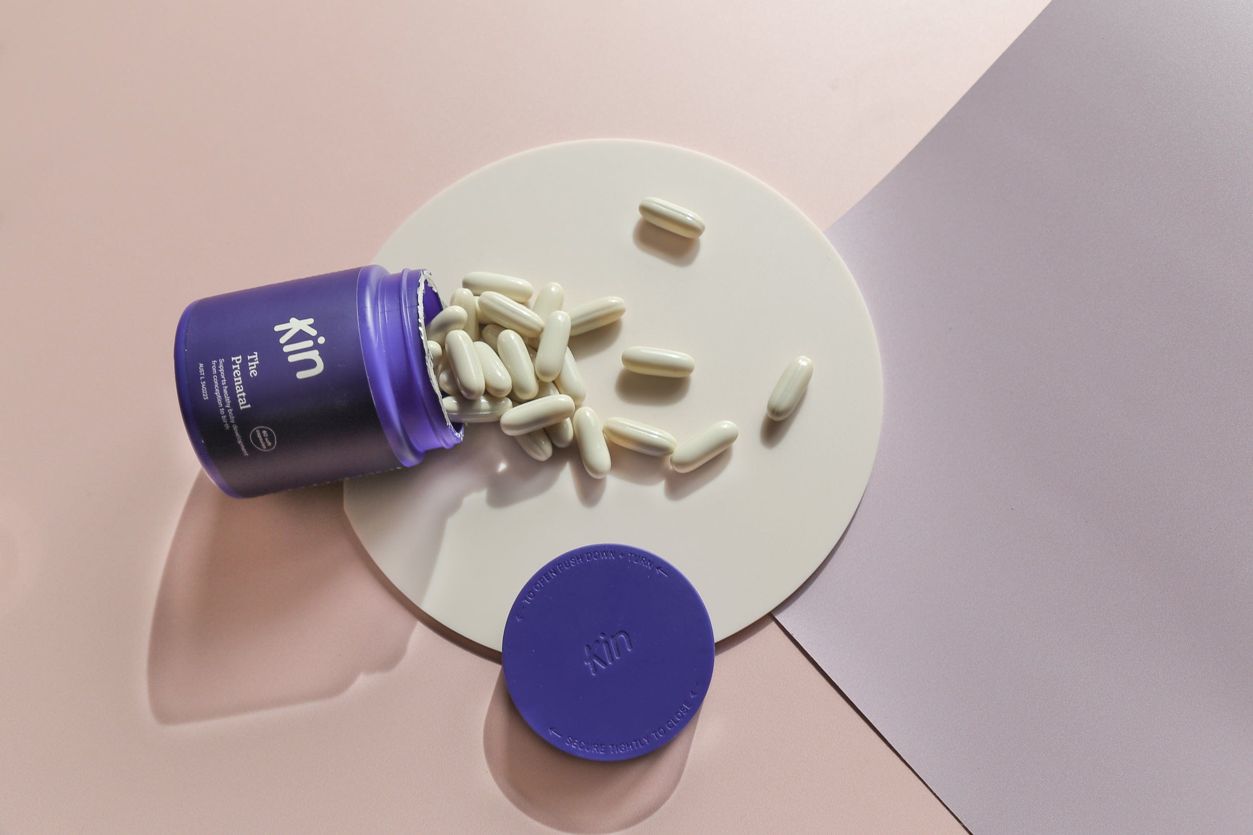 floral pink and purple backdrop with beige acrylic circle with kin prenatal vitamins - backdrop collective australia 