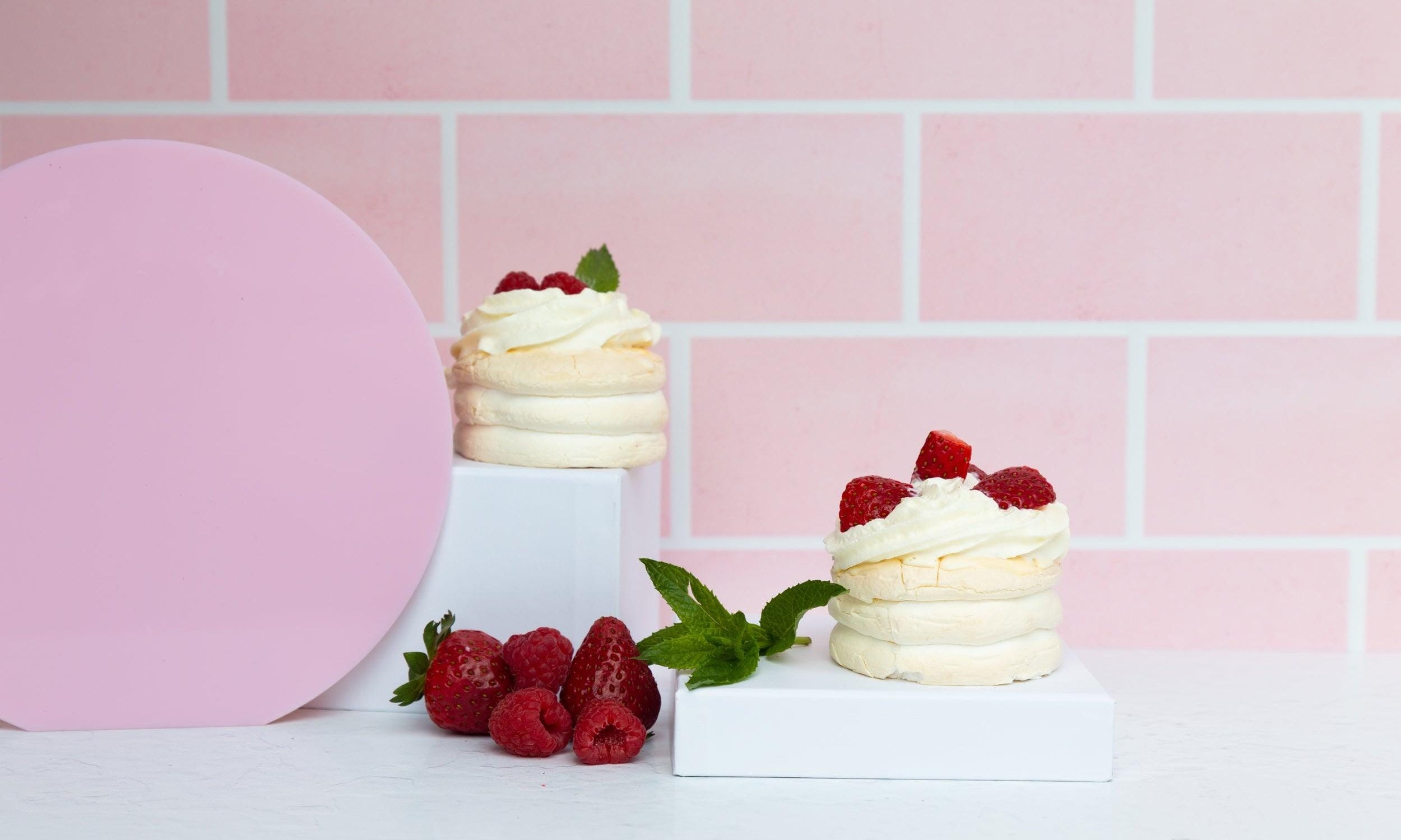 pink brick vinyl backdrop with pink large circle acrylic props and pavlova dessert and fruit - backdrop collective melbourne