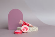 frank body lip products photographed with wild plum purple arch and travertine stone on a taupe vinyl photography backdrop - backdrop collective australia