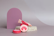 Large acrylic arch and travertine props on taupe vinyl backdrop for product photography - backdrop collective