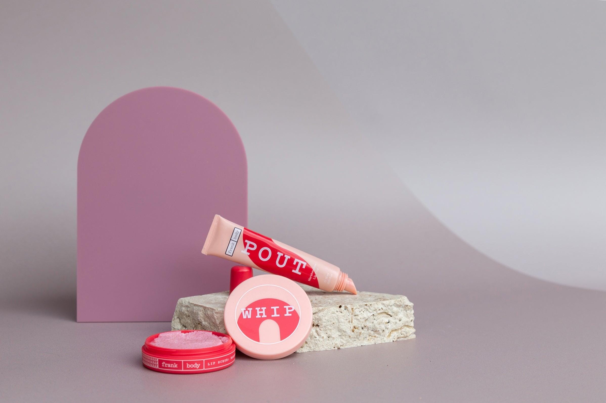 Large acrylic arch and travertine props on taupe vinyl backdrop for product photography - backdrop collective