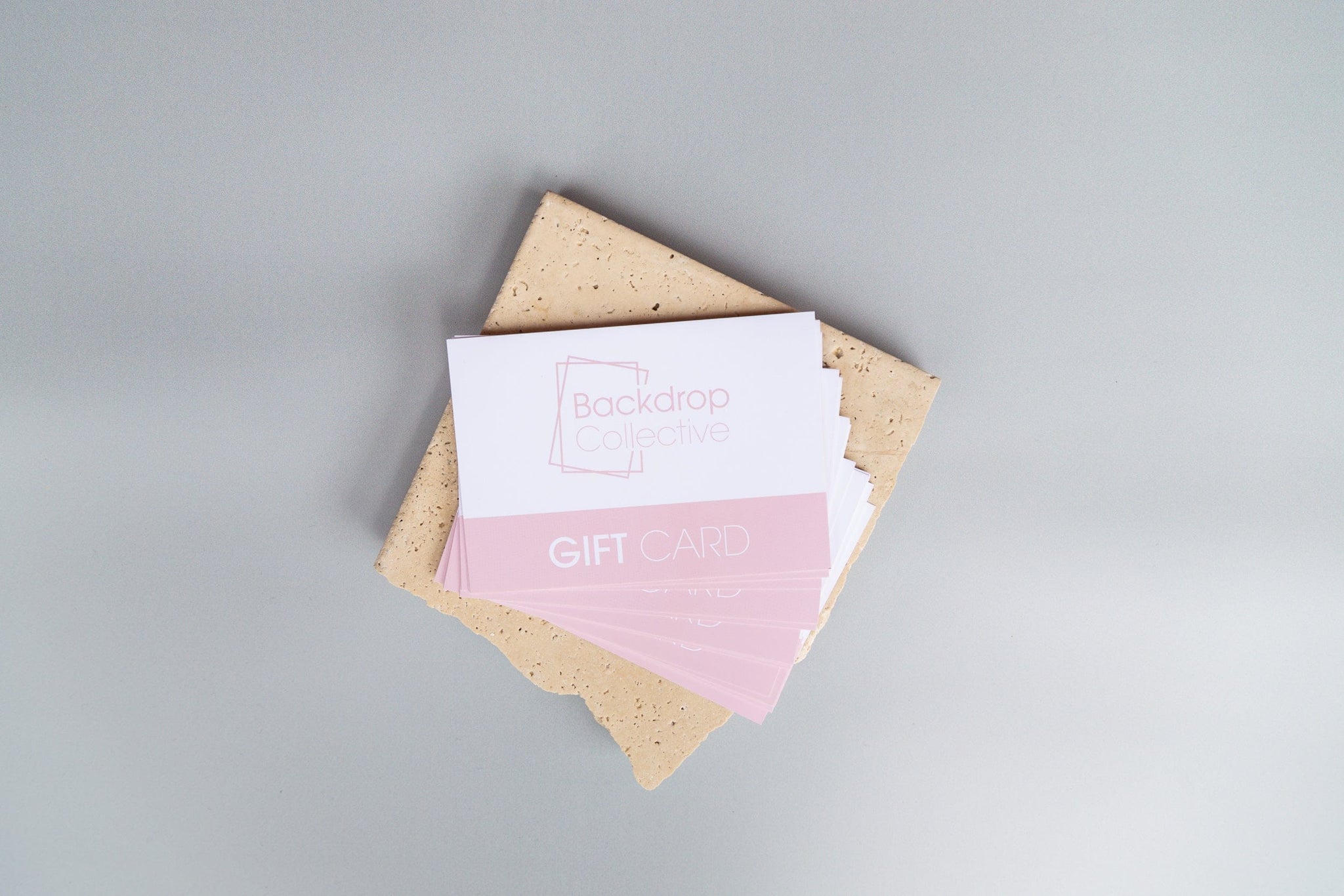 backdrop collective giftcards photographed on travertine stone and light grey photography backdrop - backdrop collective australia