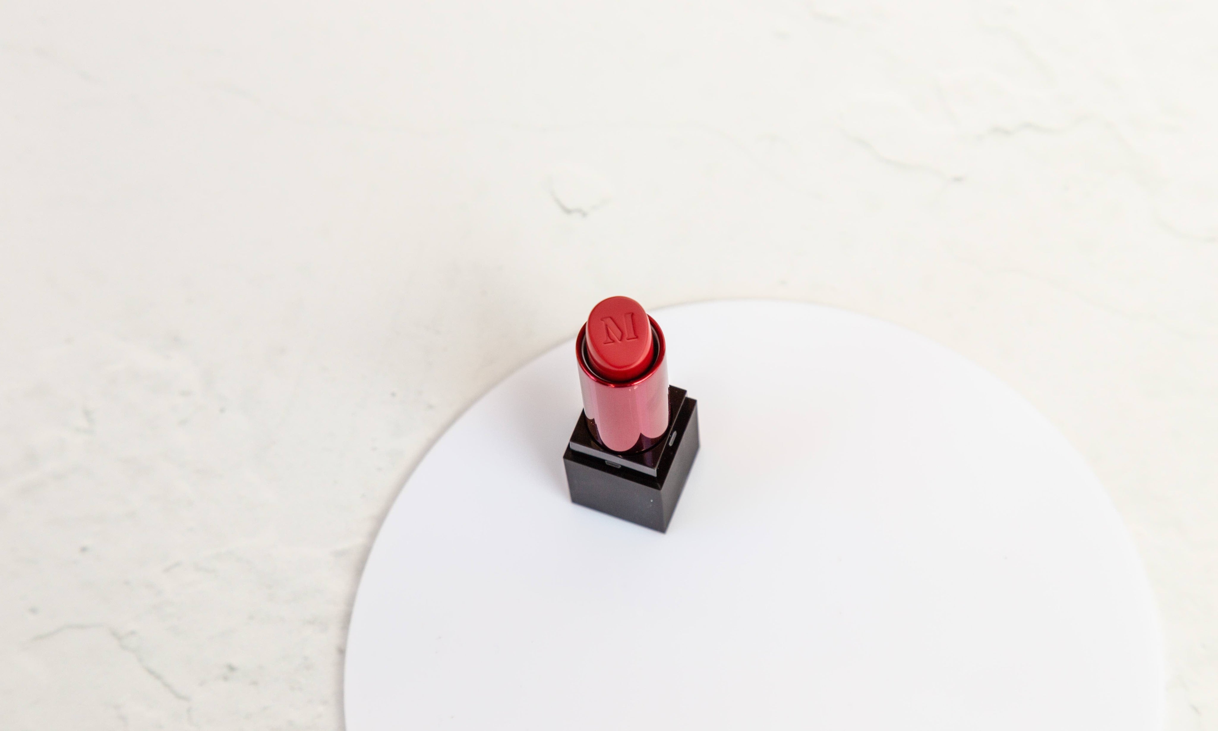 white concrete double-sided backdrop with white acrylic circle for red lipstick product photography - backdrop collective melbourne
