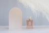Large acrylic beige arch prop with feather and chanel perfume for product photography - backdrop collective