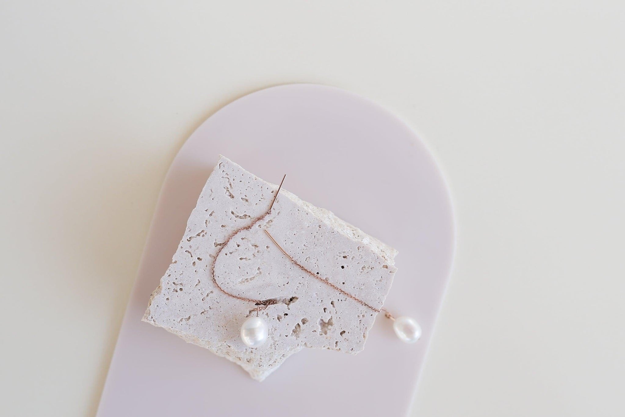 Medium beige buttercream acrylic arch and travertine props photographed pearl drop earrings - backdrop collective australia
