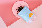 peach Medium Acrylic Circle with peach vinyl backdrop photographed with frank body body scrub - Backdrop Collective Melbourne