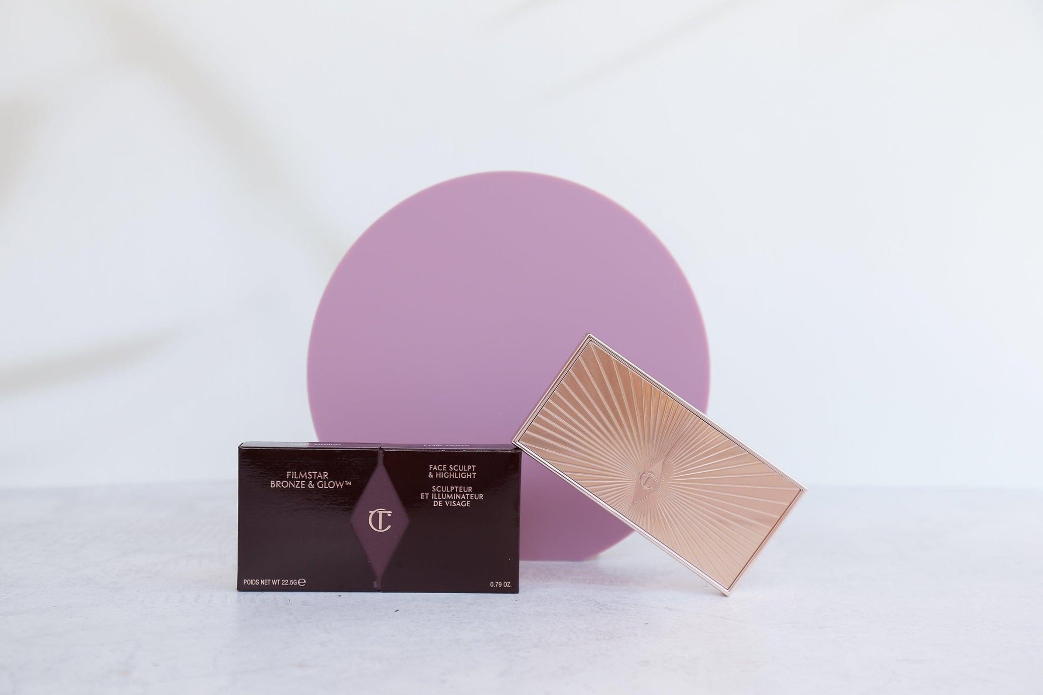purple wild plum Medium Acrylic Circle with shadow backdrop photographed with charlotte tilbury bronzer- Backdrop Collective