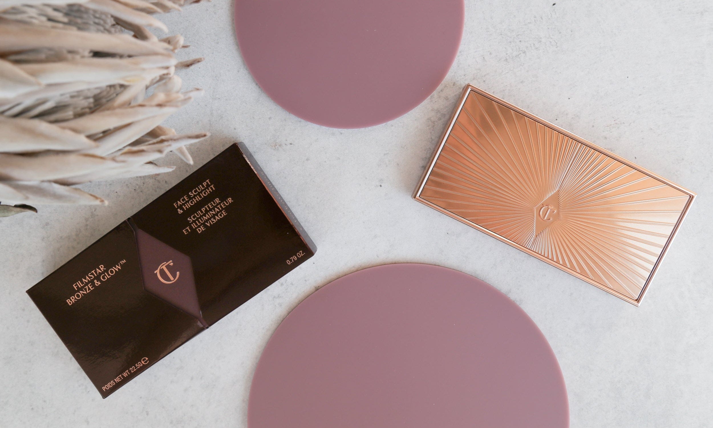 Charlotte Tilbury Bronze and glow cosmetic products photographed with wild plum purple acrylic circle props - backdrop collective australia