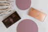 Charlotte Tilbury Bronze and glow cosmetic products photographed with wild plum purple acrylic circle props - backdrop collective australia