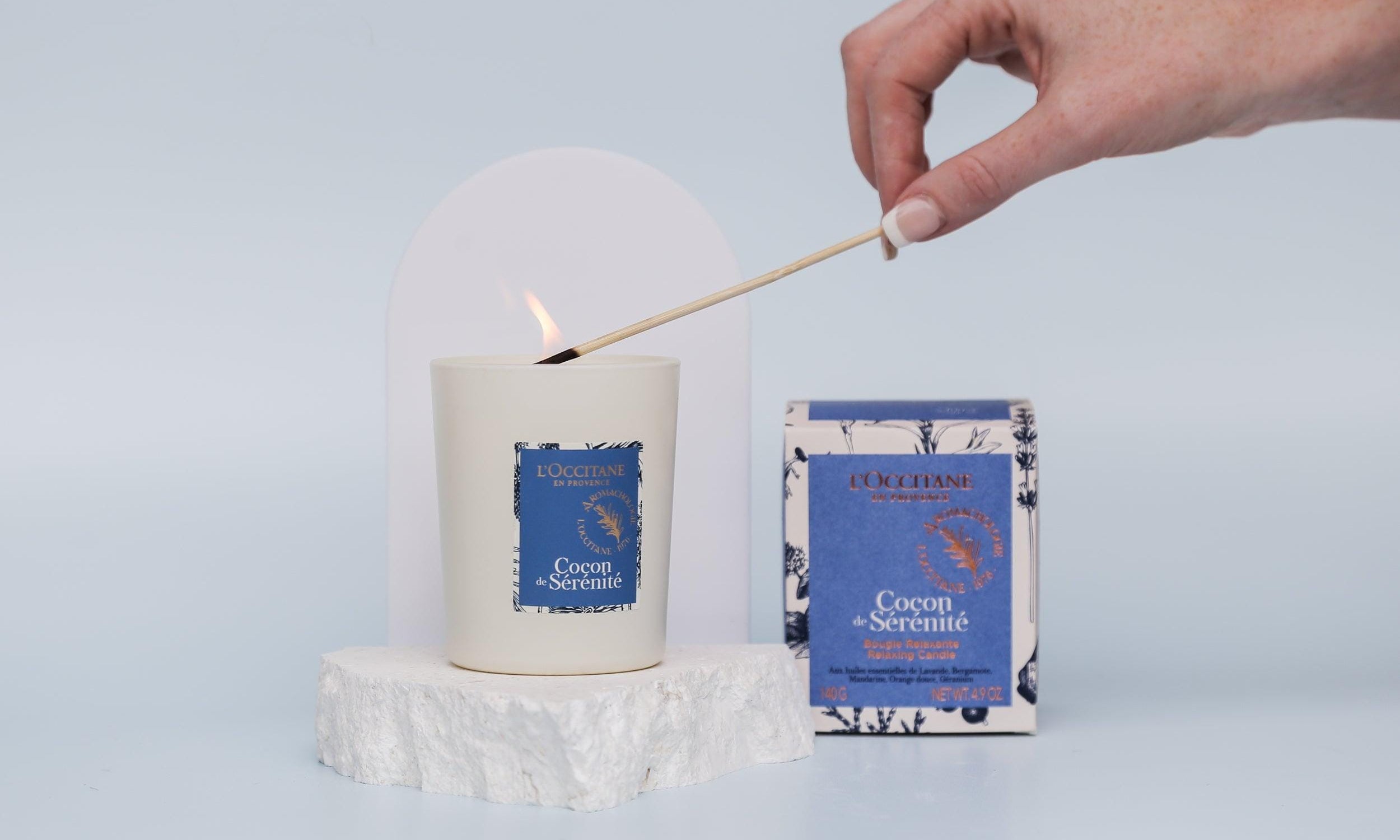 Medium white acrylic arch and white limestone props photographed with a burning candle - backdrop collective australia