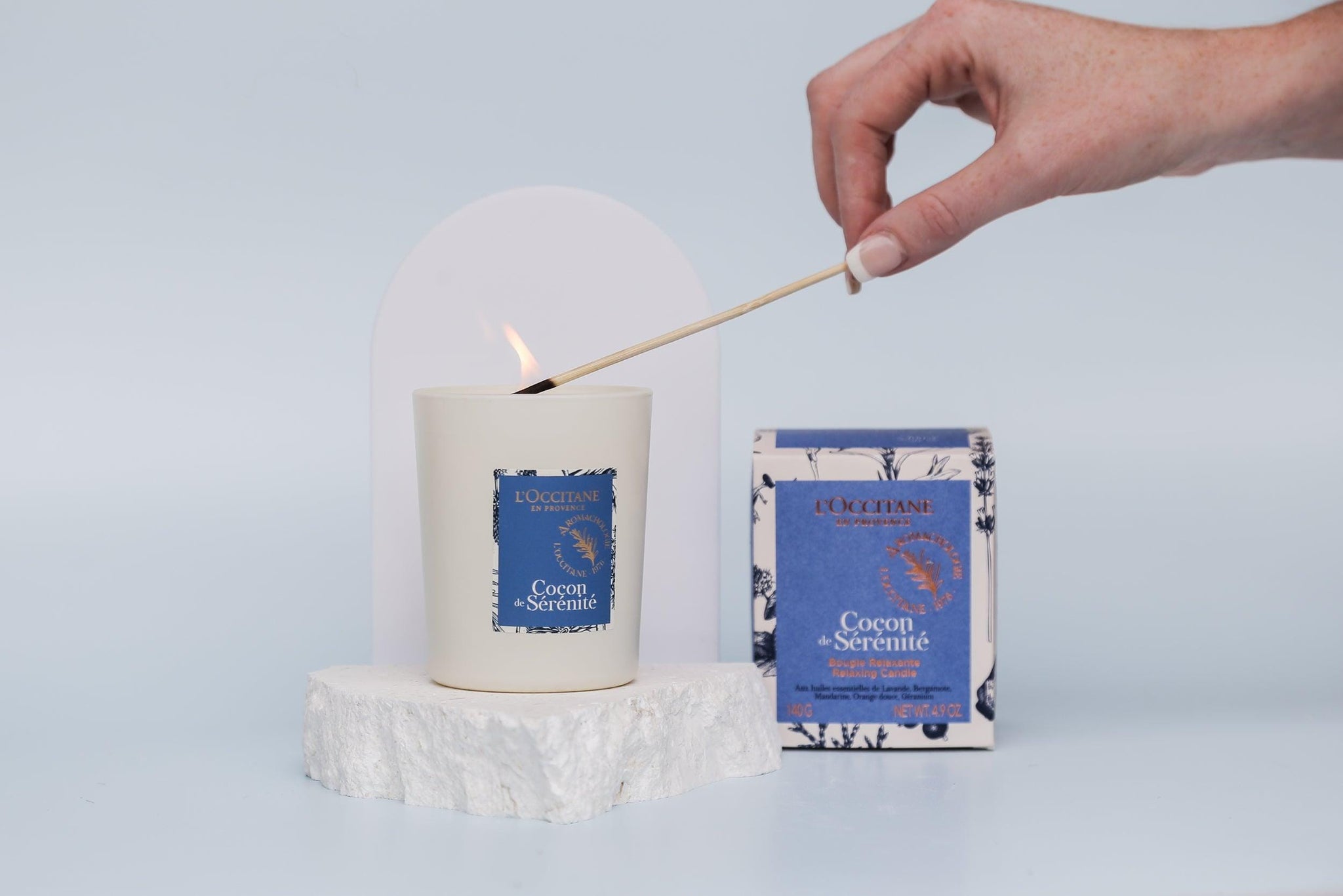 Medium white acrylic arch and white limestone props photographed with a burning candle - backdrop collective australia