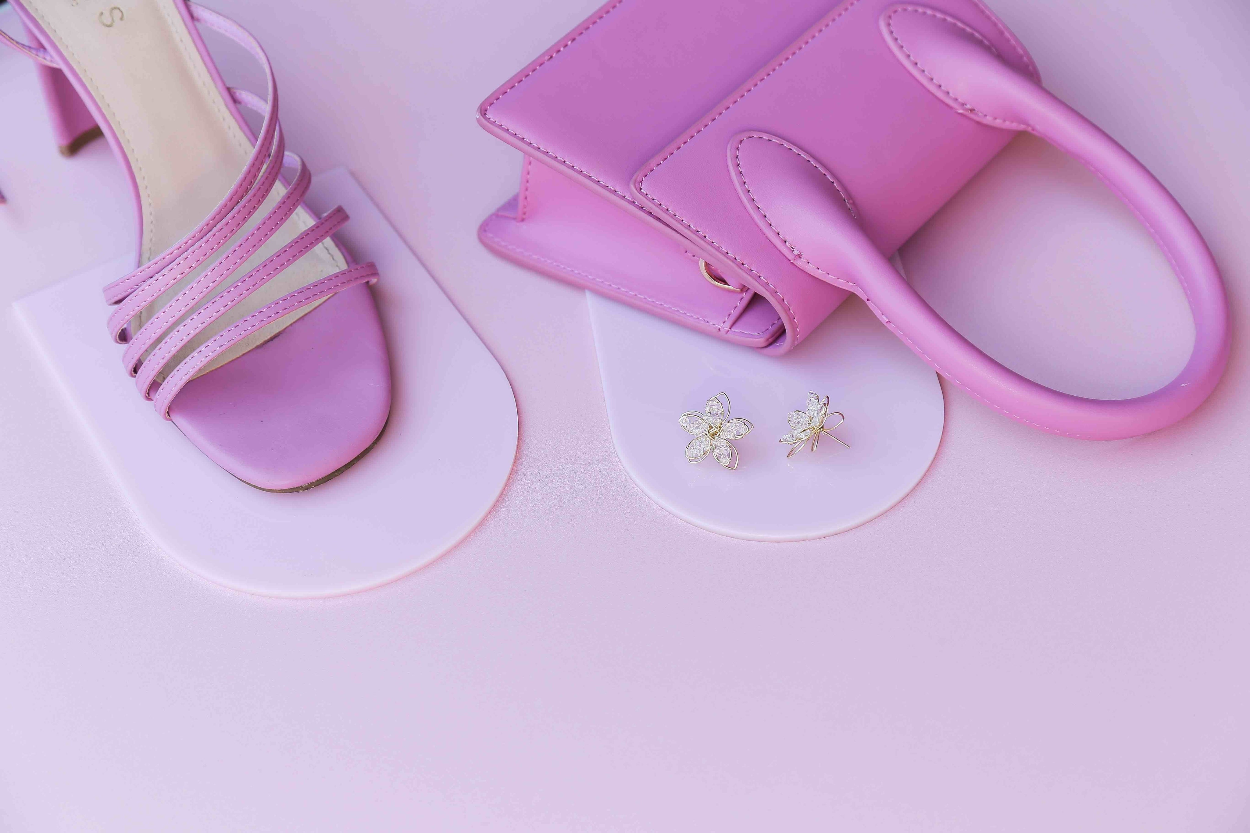 all pink vinyl photography backdrop and light link acrylic arches with pink shoes and handbag - backdrop collective australia