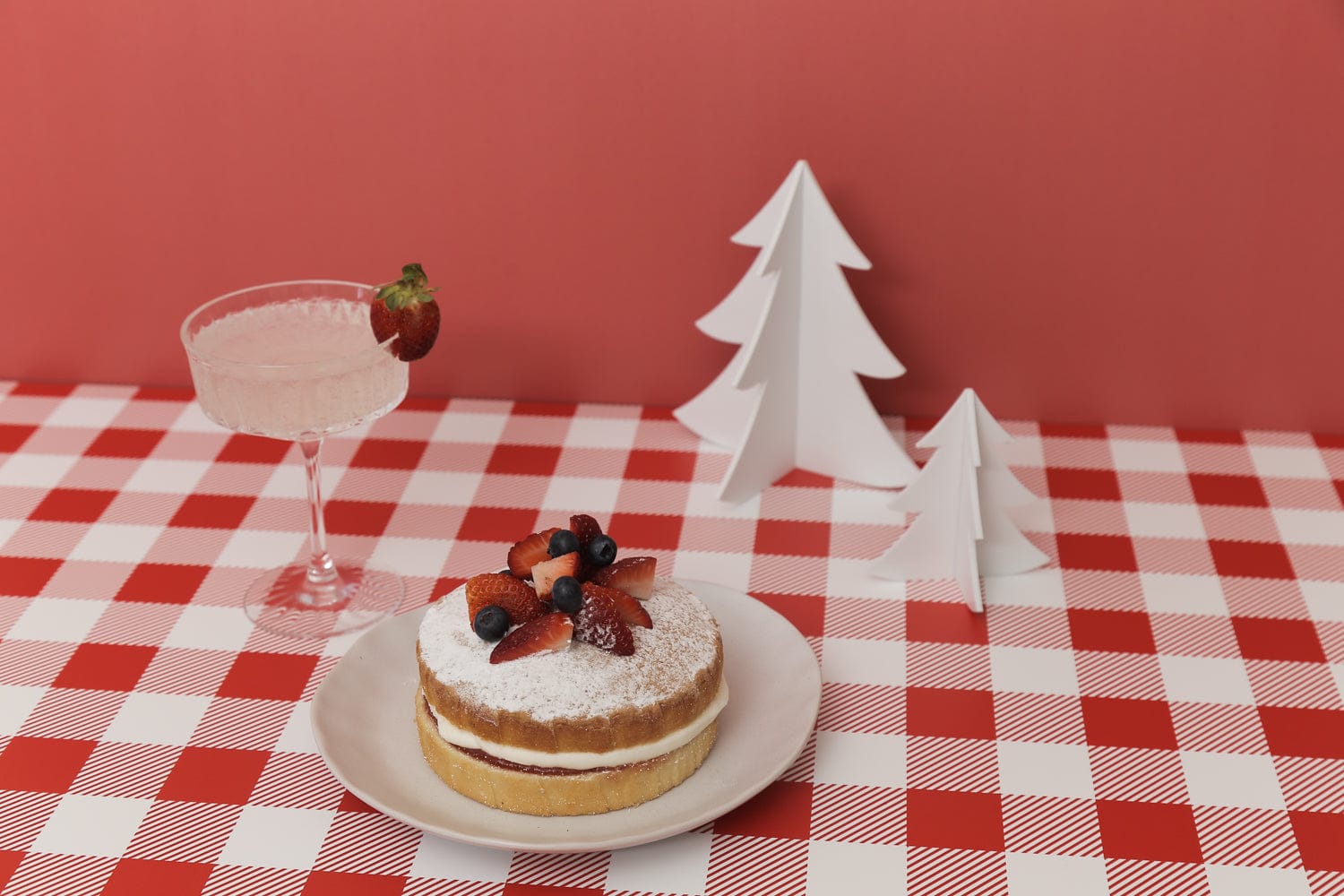 bright red photography backdrop with sponge cake and christmas props - backdrop collective melbourne