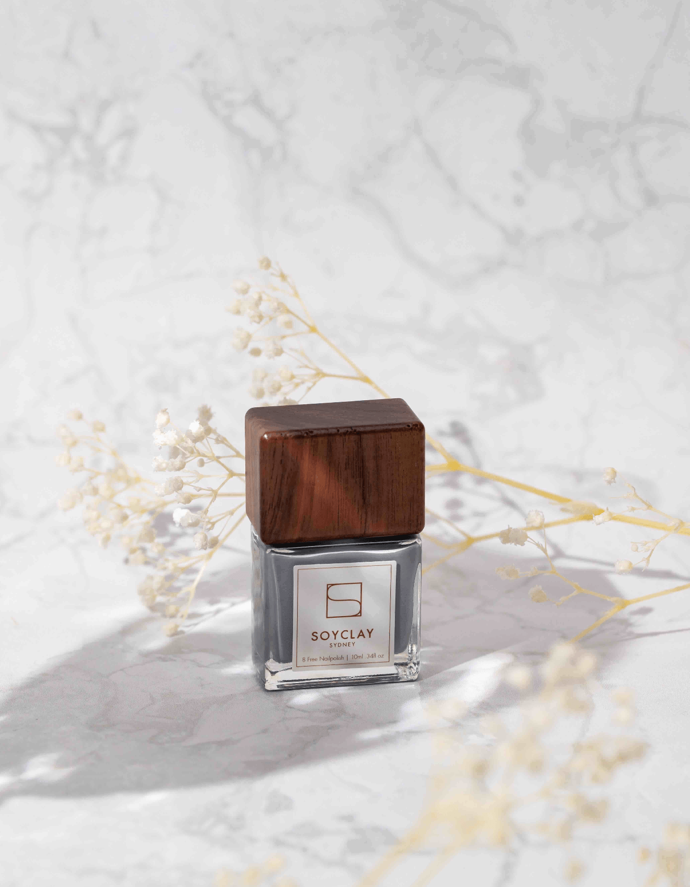 soy clay nailpolish photographed on white marble stone photography backdrop - backdrop collective australia 