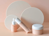 buttercream beige acrylic circle props with peach backdrop and moisturiser skincare products - backdrop collective melbourne 