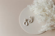 solid colour beige vinyl photography backdrops with acrylic circle props for earrings and jewellery product photography - Backdrop Collective Melbourne