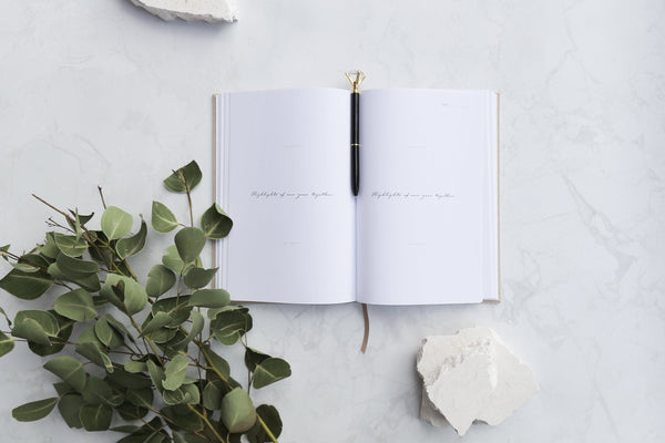 dream diary and diamond pen photographed with gum leaves on a white stone photography backdrop - backdrop collective australia 
