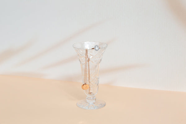 beige and peach Shadow pattern double-sided vinyl photography backdrop photographed with jewellery in a glass vase - backdrop collective Australia 