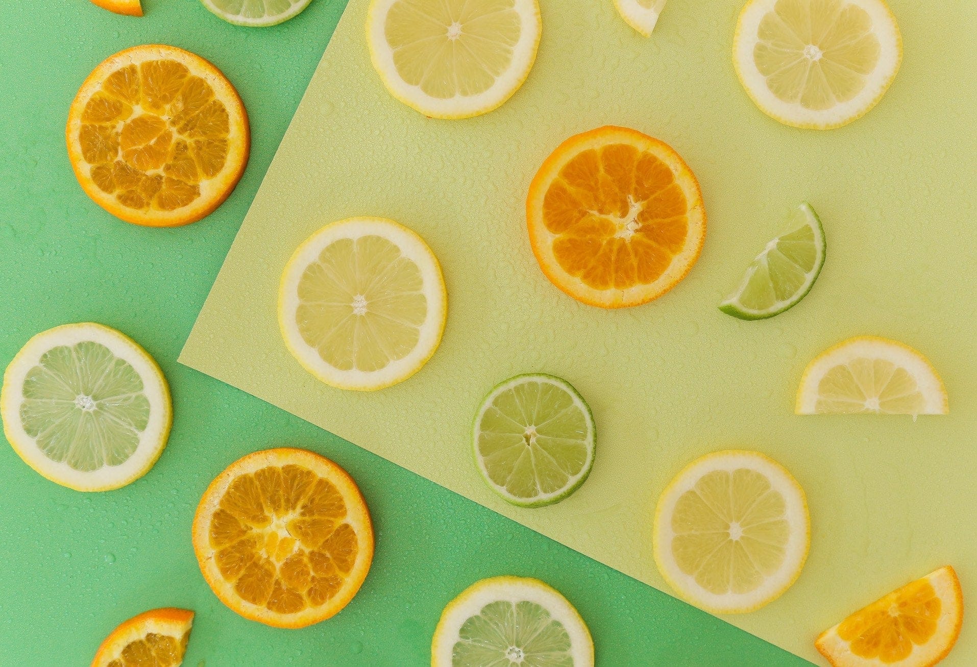 bright green and yellow vinyl waterproof backdrop photographed with different cut citrus - backdrop collective melbourne
