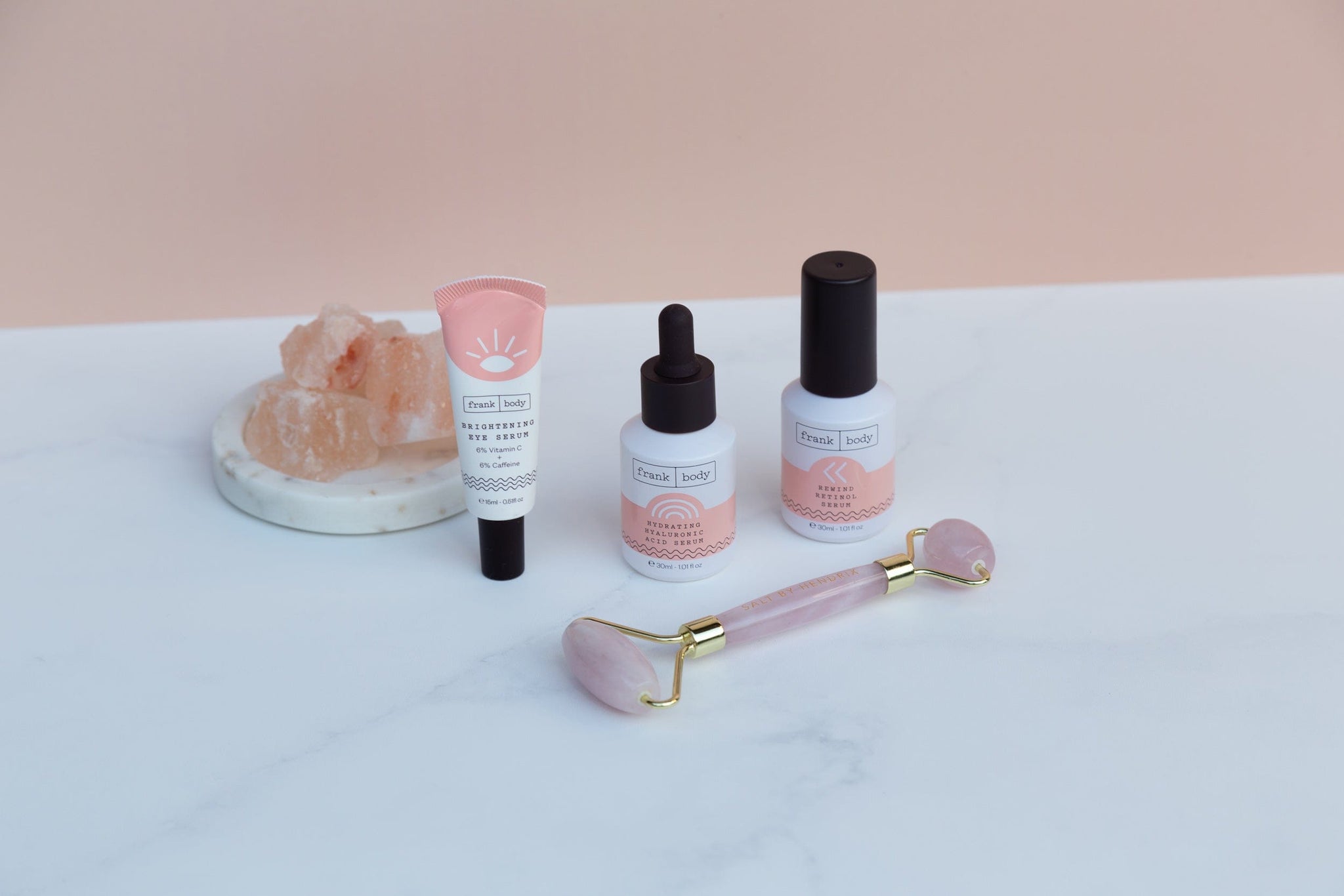 frank body skincare products and rose quartz roller photographed on granite marble double-sided vinyl photography backdrop - backdrop collective australia