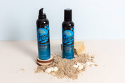 bondi sands tan photographed with sand and shells on a Sand beige double-sided vinyl waterproof photography backdrop - backdrop collective australia