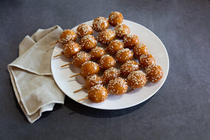 Honey chicken sticks photographed on black concrete vinyl food photography backdrop - backdrop collective australia 