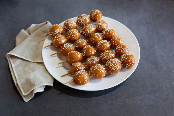 Honey chicken sticks photographed on black concrete vinyl food photography backdrop - backdrop collective australia 