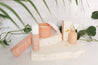 go-to skincare products with greenery photographed on white limestone natural stone props with white tiles - backdrop collective melbourne australia 