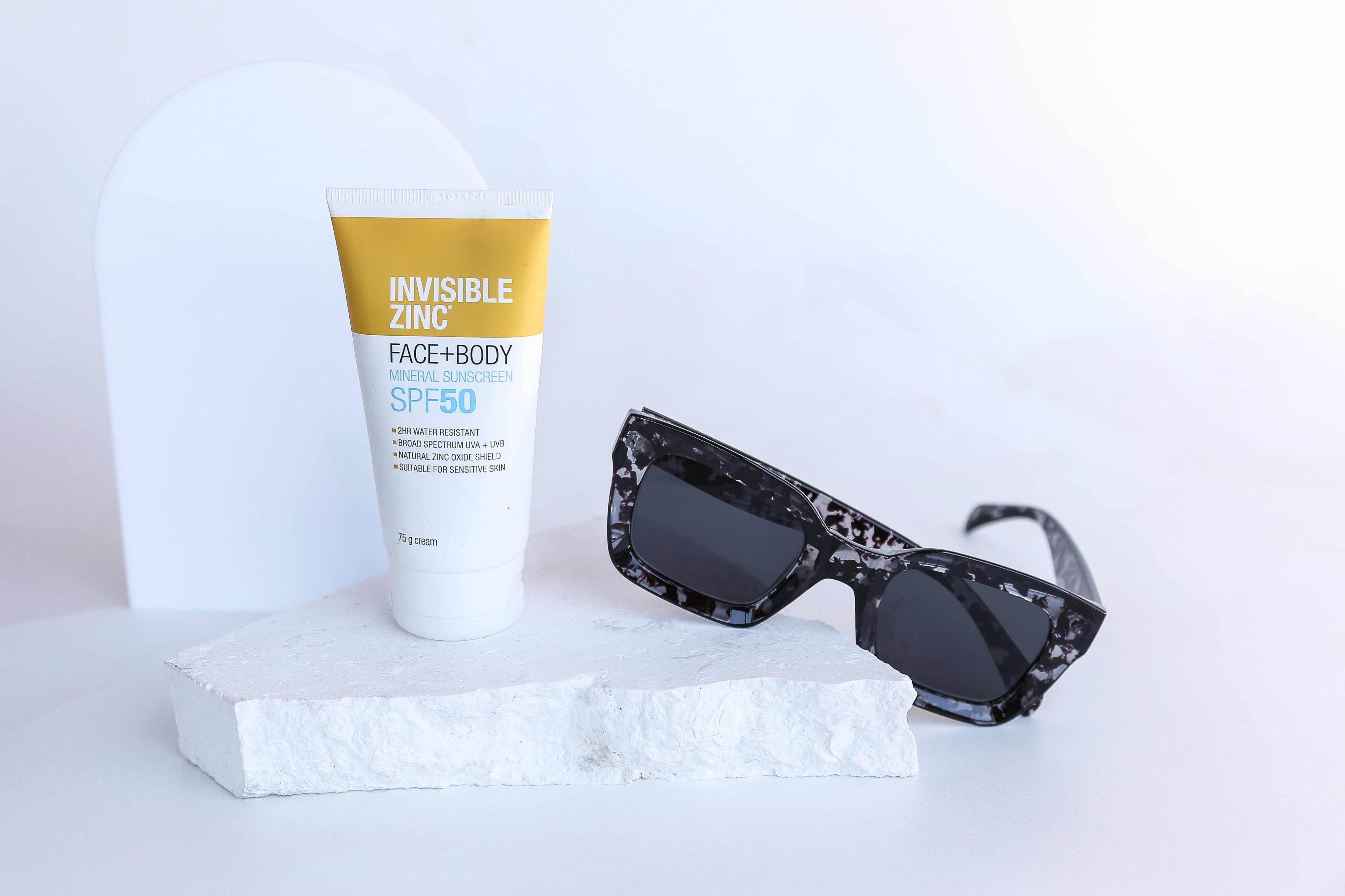 Invisible zinc and sunglasses on white limestone natural stone prop - backdrop collective melbourne australia 